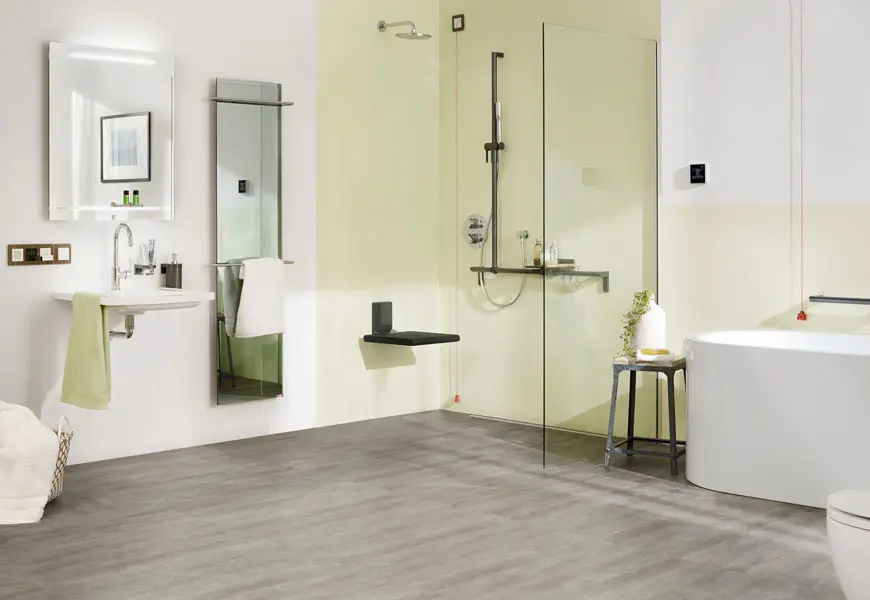 Barrier-free bathroom with level-access shower and grab rails